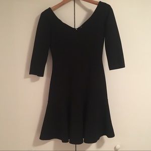 Black form fitting a-line dress.